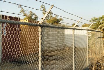 Chain link fence with security wire on top