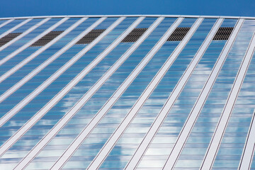 Fototapeta na wymiar Modern skyscraper blue windows glass wall with reflections.