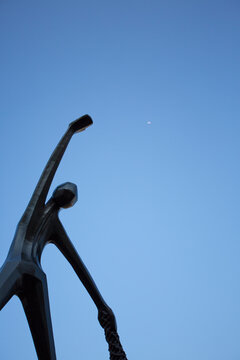 CARTAGENA, COLOMBIA, JANUARY 8: Monument in the center of the colonial city of Cartagena designed by unknown artist, man with arm up with the moon and a blue sky in the background. Colombia 2014