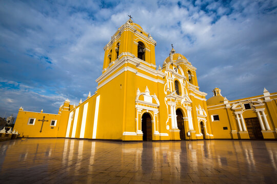 Magnificent yellow cathedral with a beautiful blue sky and light reflections in Trujillo, Peru