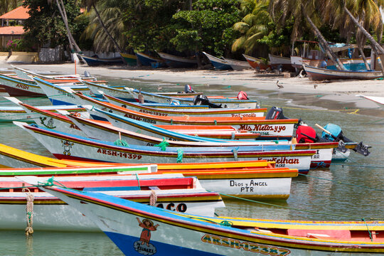 MARGARITA, VENEZUELA, APRIL 15: Colorful wooden fisher boats aligned on the beach of Pampatar on Margarita Island. Venezuela