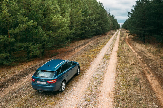 Lada Vesta Parked On Roadside. Country Road Through Forest.
