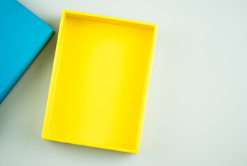 Yellow open empty squares cardboard box.