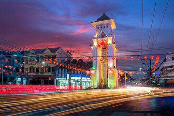 Pictures of Yala city, Thailand in the night, the lights of Yala's landmark running car Clock Tower and Car Tunnel - obrazy, fototapety, plakaty