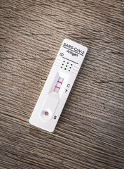 Close-up of a corona rapid test at home where you have the results after 15 minutes with the positive, two stripes test result; worried to be infected by the covid-19 virus.