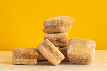 Delicious Petit four on yellow background.