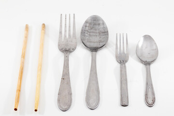 a spoon, fork and chopstick isolated on white background