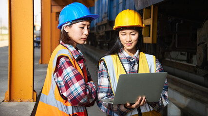 Rail logistics engineers are discussing repairing locomotive in the factory.