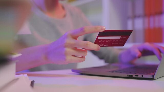 Woman using laptop and credit card with paying for shopping online.