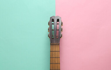Acoustic guitar neck on pink blue background. Musical concept. Minimalism. Top view. Flat lay