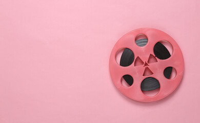 Pink retro audio reel on pink background. Minimalism music concept. Top view. Copy space