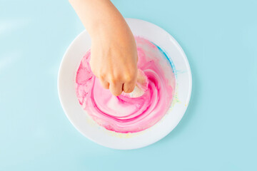 Fun kids science experiments. Step by step instruction: how to make colorful stains in milk. Step4 Colorful universe in plate of milk. Entertaining chemistry.