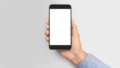 Fototapeta na wymiar Hand holding smartphone device touching screen