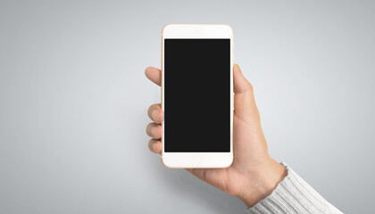 Hand holding smartphone device touching screen