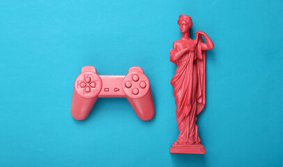 Pink gempad and antique greek statue on blue background. Gaming concept, minimalism. Flat lay. Top view © splitov27