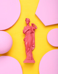 Creative layout. Pink Antique greek goddess statue with circles on yellow background. Minimalism. Flat lay. Top view. Flat lay