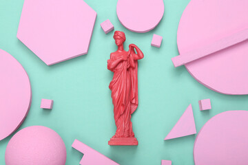 Creative minimal layout. Pink Antique greek goddess statue with different geometric shapes on mint blue background. Minimalism. Concept art. Flat lay. Top view.