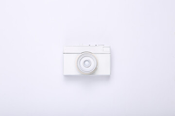 Creative layout. White retro camera on white background. Minimalism. Concept art. Modern still life. Flat lay. Top view.