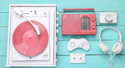 Concept art. Creative retro layout of vinyl record player and other retro attributes of 80s on blue...