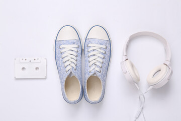 Creative layout. Sneakers and headphones on white background. Minimalism. Top view. Flat lay