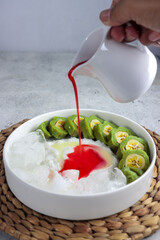 Es Pisang Ijo, Makassar's Indonesia specialty dessert is made from banana wrapped in a green flour...