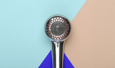 Shower head for the bathroom on colored background. Top view