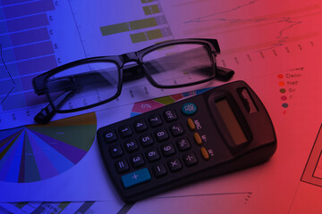 Classic eyeglasses and calculator with graphs and charts. Neon light. Economic calculation,...