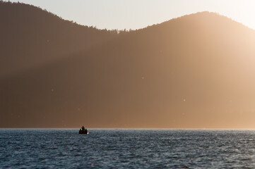 Fototapeta premium people on the boat trip. fishers at the sunset