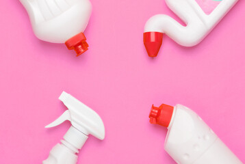 Bottle of detergent on pink background. House cleaning concept. Minimalism. Top view. Copy space