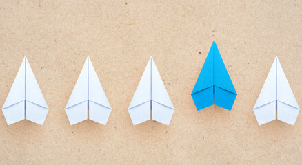 Blue paper plane leading among a white planes, Business competition and Leadership concept