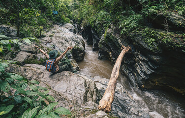 Tourist woman sitting on the rock at 