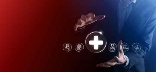 Businessman hold virtual plus medical network connection icons. Covid-19 pandemic develop people awareness and spread attention on their healthcare.Doctor,document,medicine,ambulance,patient icon.