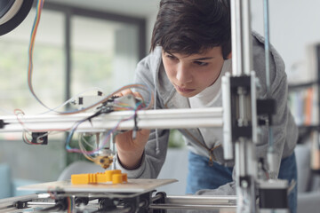 Young student using a 3D printer