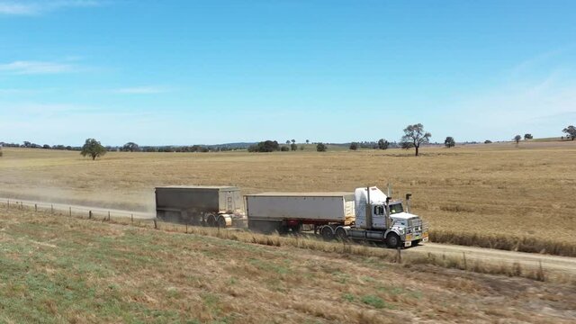 2020 - An excellent aerial shot of a twelve wheeler towing a vehicle behind it in the countryside of Parkes, New South Wales, Australia.