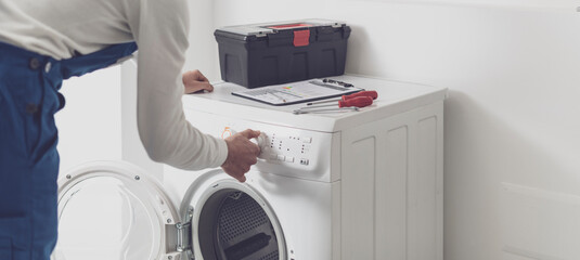 Professional repairman fixing a washing machine