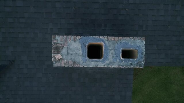 Rising Aerial Top Down View of a Chimney Stack on a House