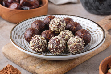A plate with homemade raw chocolate energy balls close-up. Healthy vegan and vegetarian food.