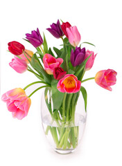 Fototapeta premium Many beautiful colorful tulips with leaves in a glass vase isolated on transparent background. Photo with fresh spring flowers for any festive design
