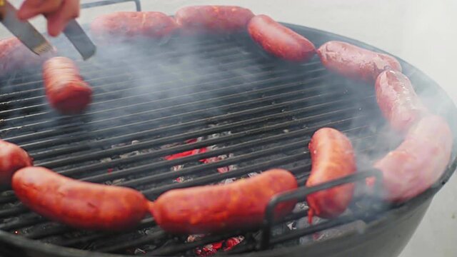 Panning Shot of Rolling Mexican Grill Sausage(Chorizo) Surrounded by Ring of Sausage on BBQ