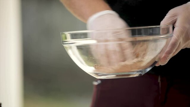 Mixing Spice Seasoning with Gloved Hand