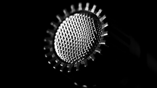 Dynamic microphone grill capsule for amplifiers, in a music studio, with shift in lighting 
(extreme close up)