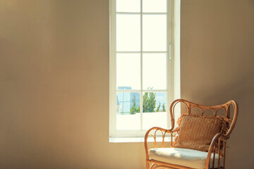Vintage chairs are standing near a wall of the sun's rays and the shadows.