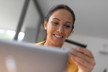 Young woman doing online shopping with her credit card