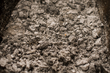 charcoal and ash in the grill close-up background