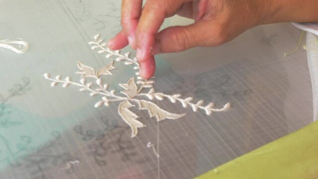 Close up of a hand stitching embroidery in The Philippines.