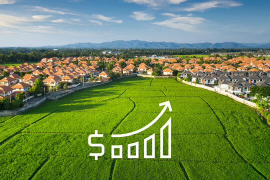 Land for sale and investment in aerial view. Include green field, agriculture farm, residential house building, village. That real estate or property. Plot of land lot for subdivision or development.