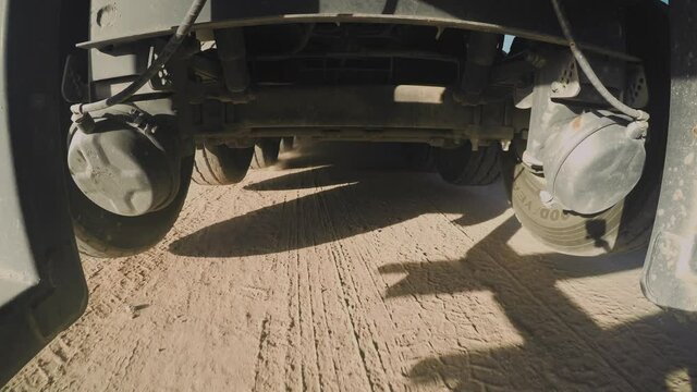 Industrial machinery. Truck driving on Muddy Terrain. Very Interesting Point of View. 4K camera is under a truck while driving on mud and water. 4x4 Truck Drive. 4K footage.