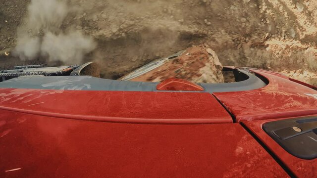 Truck Struggles Hard While Driving on Muddy Terrain. Top view for a red truck wheel struggles hard while driving back and forth on mud and water. 4x4 Truck Drive. 4K footage