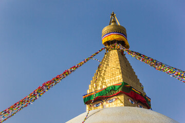 Golden spire and prayer flags at the Boudhanath stupa in Kathmandu