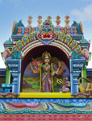 Fototapeta na wymiar Kali statue on hindu temple tower in India 